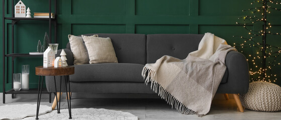 Interior of living room with grey sofa and Christmas decorations