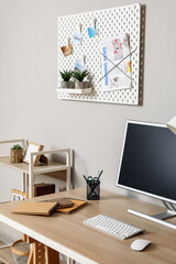Interior of modern office with workplace and pegboard