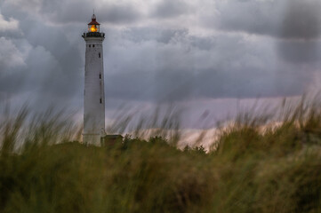The majestic Hvide Sande Lighthouse stands tall on the Danish coast, a symbol of maritime heritage...