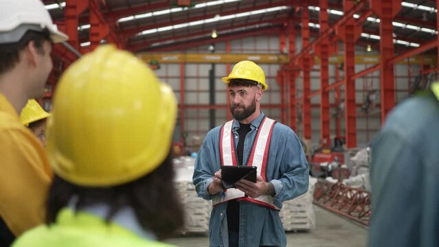 Blue collar worker work at metal sheet factory.