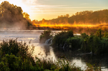 Sunrise over widest waterfall in Europe-Ventas Rumba in Kuldiga, Latvia, during sunrise in autumn