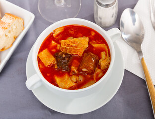 Callos a la Madrilena served on wooden table with serving pieces