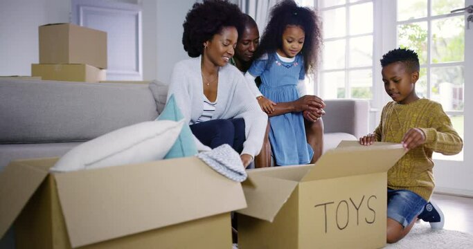 Family, unpacking and toy box in new home, children, real estate and excited with fun, cheerful and property. Parents, mother or father with kids, siblings or moving with mortgage, house or cardboard