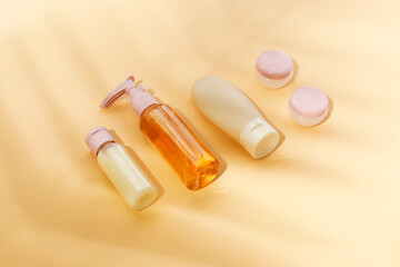 Set of travel cosmetic products on orange background