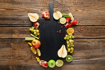 Composition with cutting board, fresh vegetables and fruits on wooden background