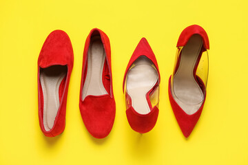 Different stylish red shoes on yellow background