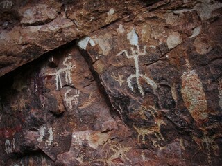 Multiple petroglyphs on cave wall - Snake Gulch, Arizona