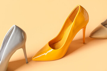 Different stylish high heels on yellow background