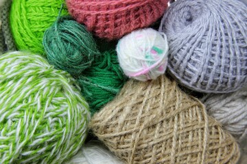 a continuous background of various types of colored wool rolled into a ball. balls of wool for knitting of different colors lie randomly next to each other 