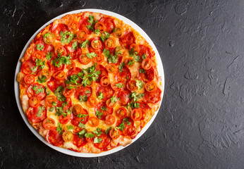 Hot pizza with sliced sausage, cheese and cilantro