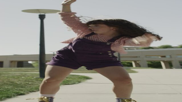 Slow motion of girls watching awkward friend dancing in roller skates  - vertical video / Salt Lake City, Utah, United States