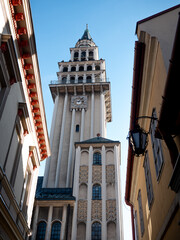 View of Cathedral of St. Nicholas in Bielsko-Biała from the street between builidings.