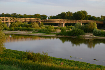 Fototapeta premium View on Pont de Pouilly-sur-Loire bridge 496 km from the source and 496 km from the mouth of the Loire river near Pouilly-sur-loire, Central France ar sunset