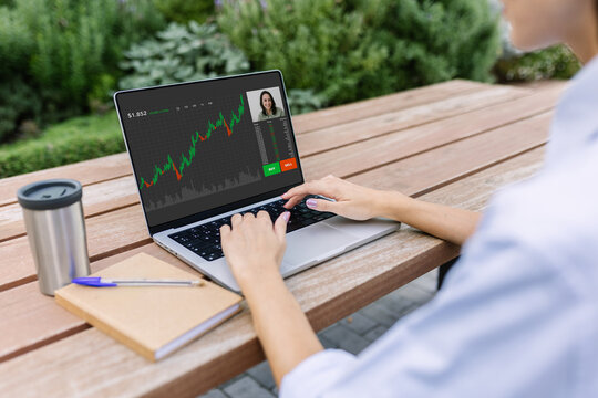 Unrecognizable young businesswoman learning stock market online. Rear view of adult student having a video call with professional trader. Investment and business opportunity concept - Powered by Adobe