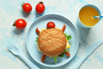 Plate with funny children's breakfast in shape of turtle on light blue table