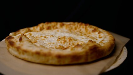 The chef prepares the Georgian dish khachapuri and cheese pie. Chef's hands prepare khachapuri on the kitchen table. prepare a traditional