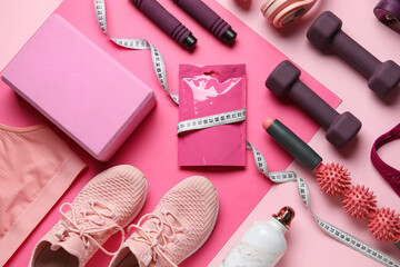 Composition with bag of snacks, sports equipment and shoes on pink background