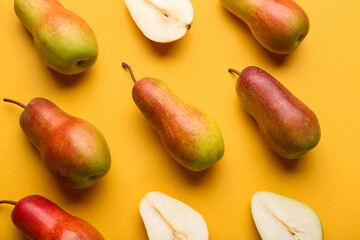 Ripe pears on yellow background