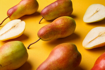 Ripe pears on yellow background
