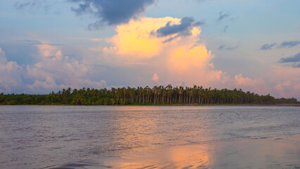 Sunset reflecting in the water of the lake at Barra Vieja in Acapulco city