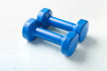 Blue dumbbells on white background