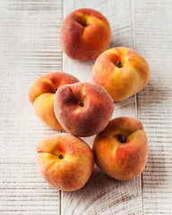 Naklejka na ściany i meble Ripe fruit peaches on a white wooden background. Fruit. 