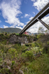 Magnificent view of the river in a deep canyon in the city of Banos, Ecuador. Big bridge across the river.