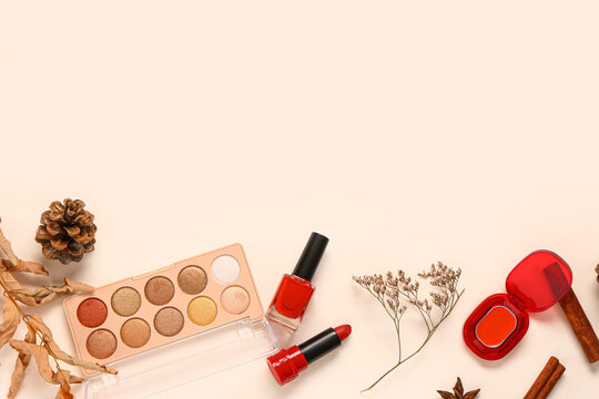 Autumn composition with different makeup products on light background
