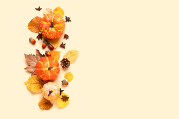 Obraz premium Autumn composition with ripe pumpkins, spices and fallen leaves on light background
