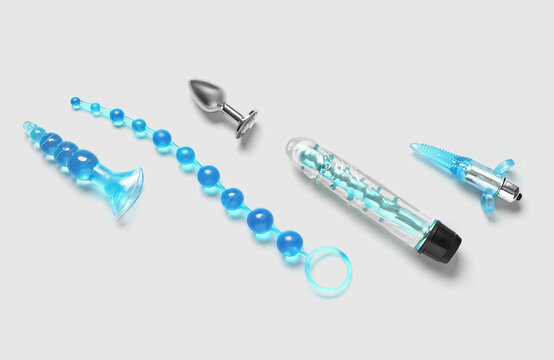 Blue vibrator and anal plugs from sex shop on white background