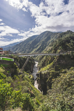 Magnificent View Of The River In A Deep Canyon In The City Of Banos, Ecuador. Big Bridge Across The River.