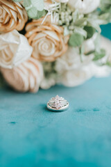 wedding bands in front of bouquet