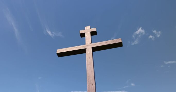 wooden christian cross on a blue sky background, wooden orthodox cross on a sky background with clouds