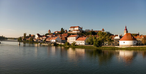 Fototapeta na wymiar Ptuj in Slovenia, panoramic view with river Drava in foreground.