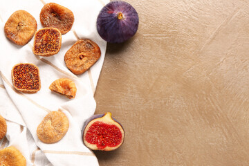 Sweet dried figs and fresh fruits on brown background