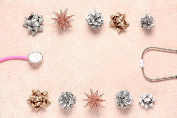 Christmas composition with stethoscope, pine cones and ribbons on beige grunge background