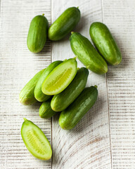 Juicy fresh cucumbers on a white wooden background. Vegetables