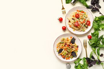 Plates with tasty pasta primavera on white background