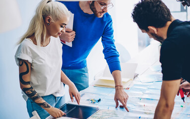 male and female employees of business tourism agency having meeting for discussing tours