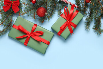 Gift boxes with Christmas decorations on blue background