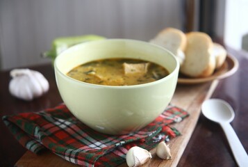 bowl of soup with bread and garlic