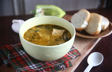 bowl of soup with bread and garlic