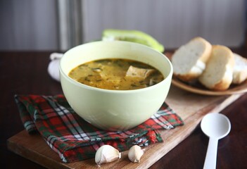 bowl of soup with bread and garlic