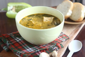 bowl of soup with bread on the table