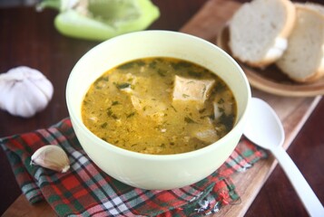 bowl of soup with bread and garlic
