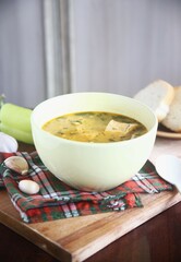 Close up bowl of soup with bread and garlic