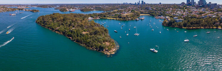Naklejka premium Panoramic aerial drone view of Berrys Bay, Balls Head Reserve and Waverton Peninsula on the lower North Shore of Sydney, New South Wales, Australia on a sunny day 