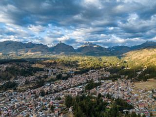 Fototapeta na wymiar Beautiful aerial view of Andes mountain peaks covered with snow at sunset. City of Huaraz, Peru.