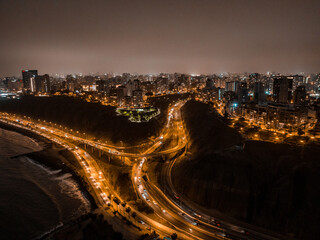 Fototapeta premium Aerial panoramic view of buildings in Miraflores and Barranco district in Lima. Night.
