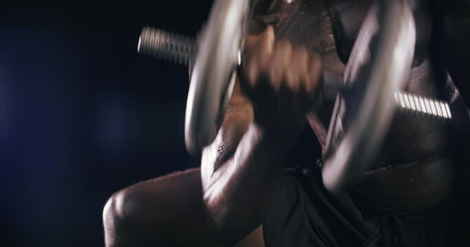 Studio, dumbbell or strong man training, exercise or workout for arm power, muscle or body fitness. Concentration curls, bodybuilder or African athlete lifting weights for biceps on black background